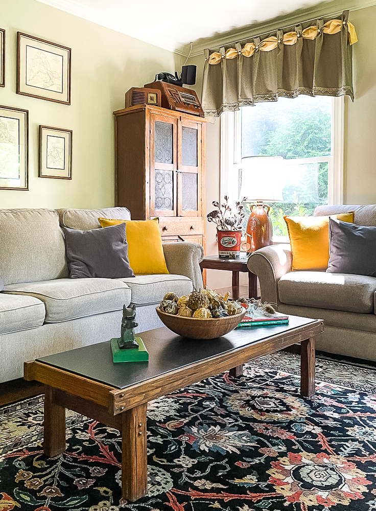 Family room decorated for fall in traditional colors