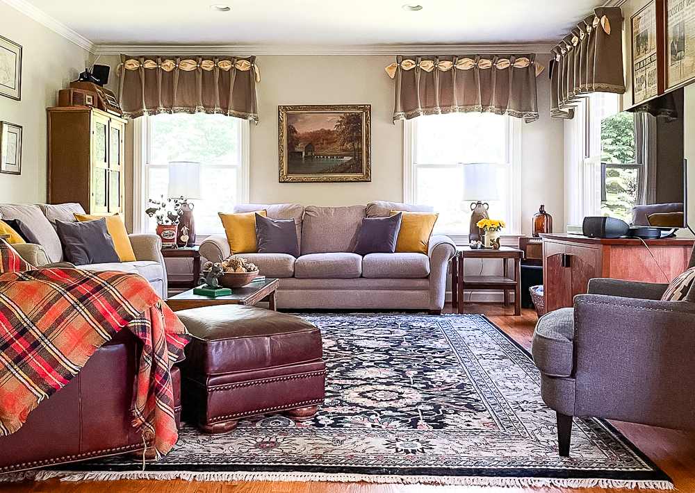 Family room decorated for fall in traditional colors