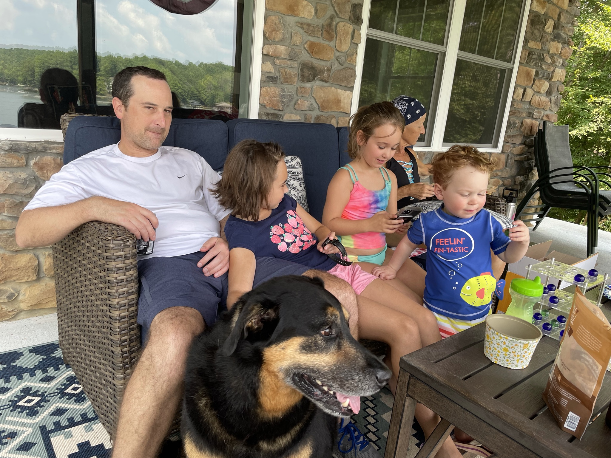 Family relaxing on a lakeside patio