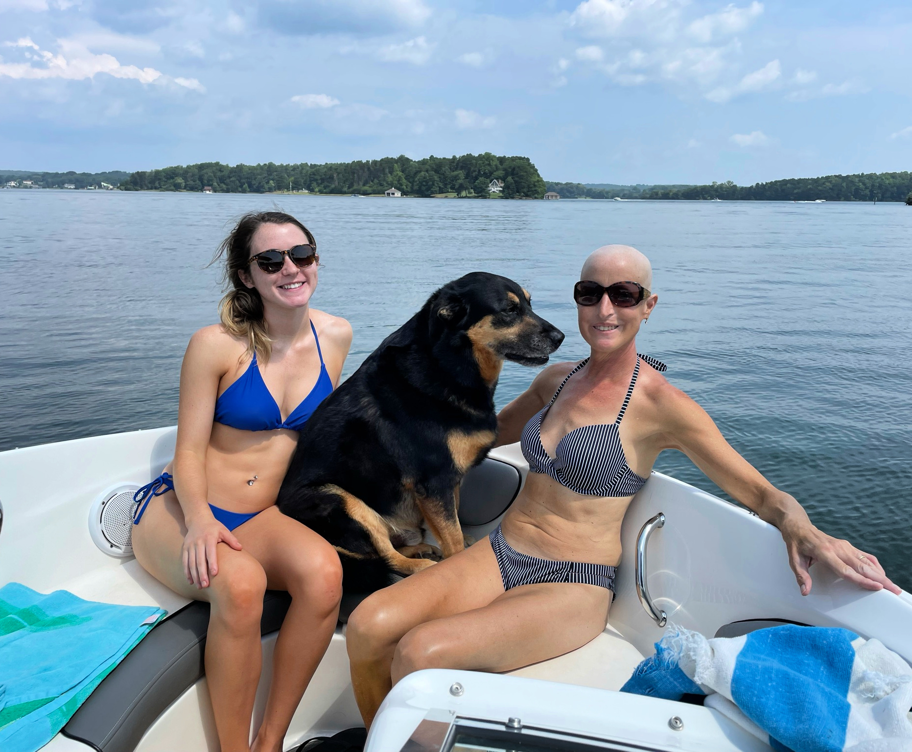 Two women and a dog on a boat at Smith Mountain Lake, VA