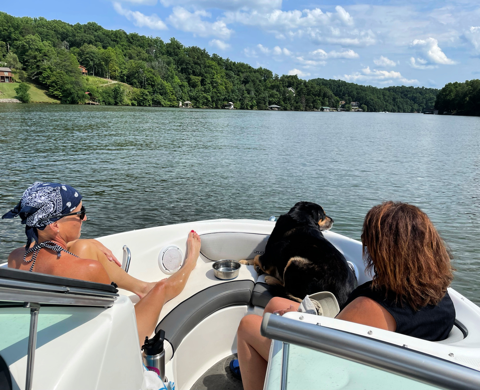 Two women and a dog on a boat at Smith Mountain Lake, VA