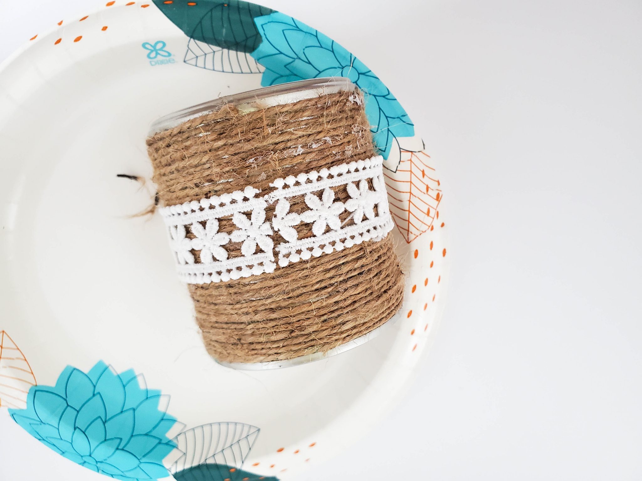 Upcycled can decorated with twine and lace