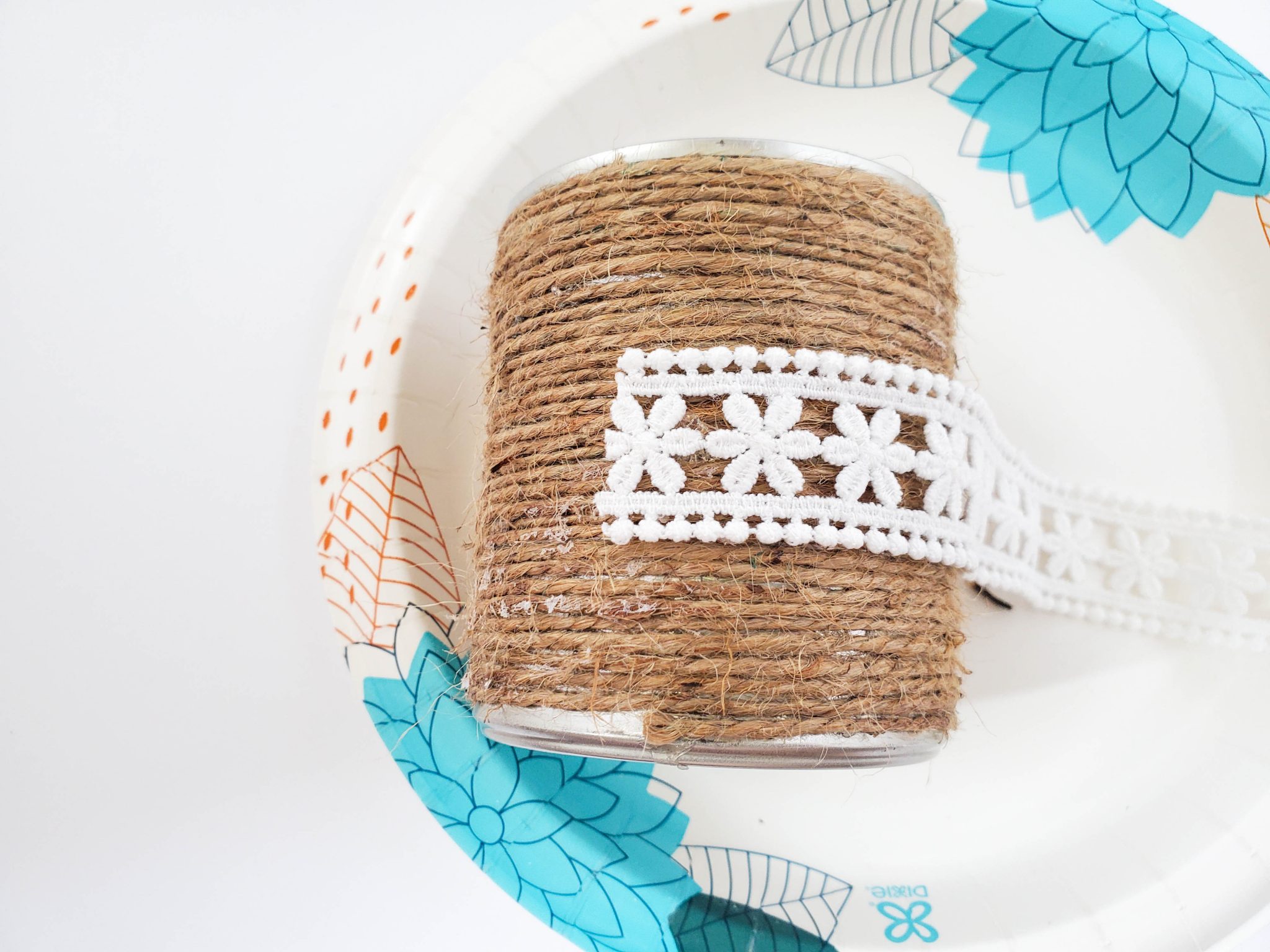 Upcycled can decorated with twine and lace