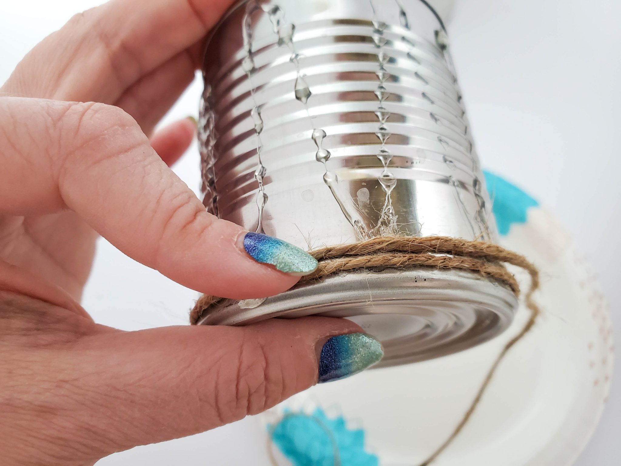 Gluing twine to a can