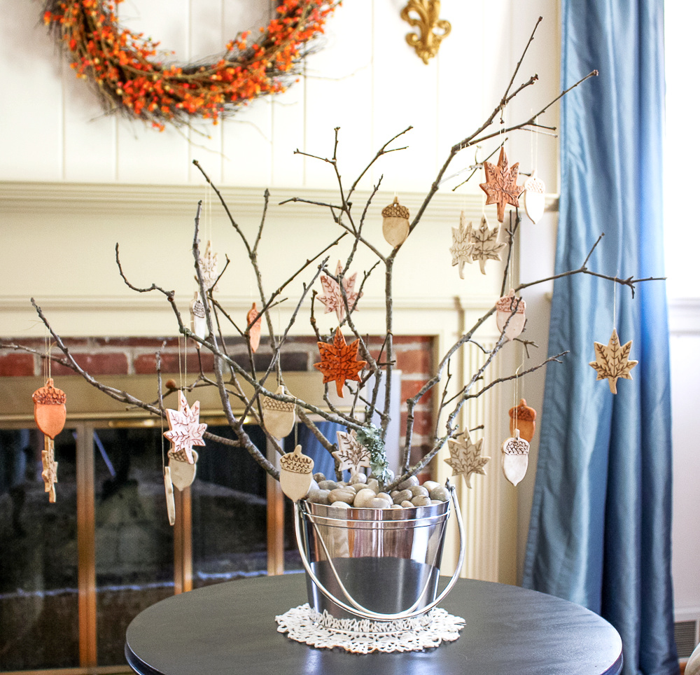Fall Ornaments from Clay hanging on a tree branches in a silver ice bucket