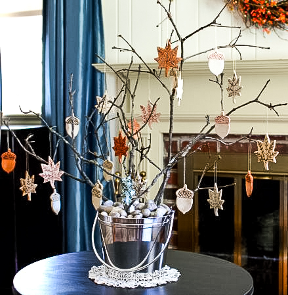 Fall Ornaments from Clay hanging on a tree branches in a silver ice bucket