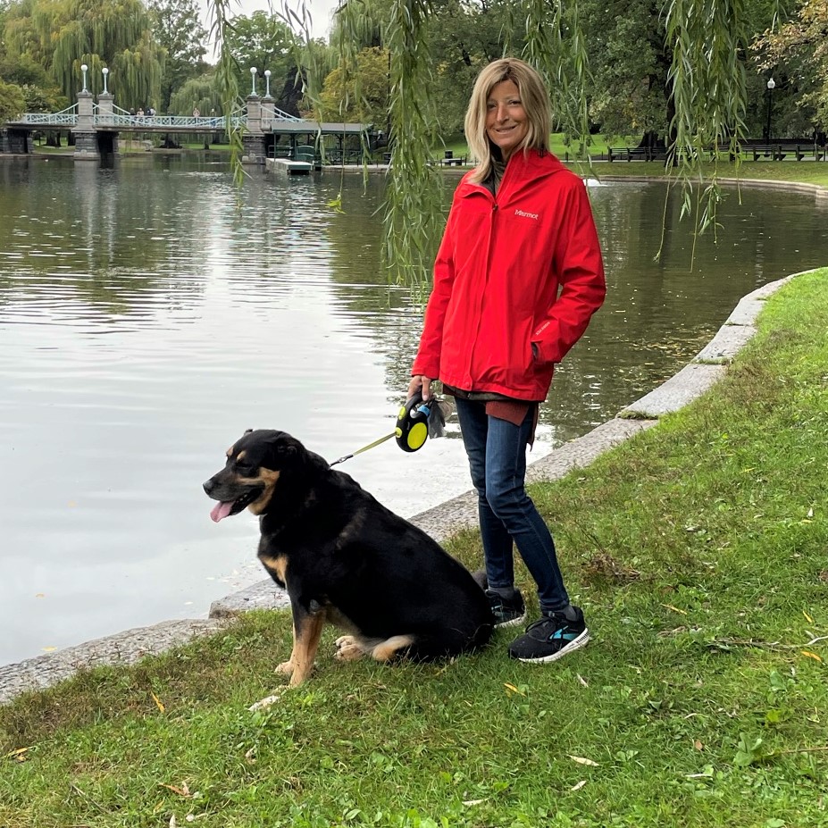 Woman and dog walking in a park in Boston