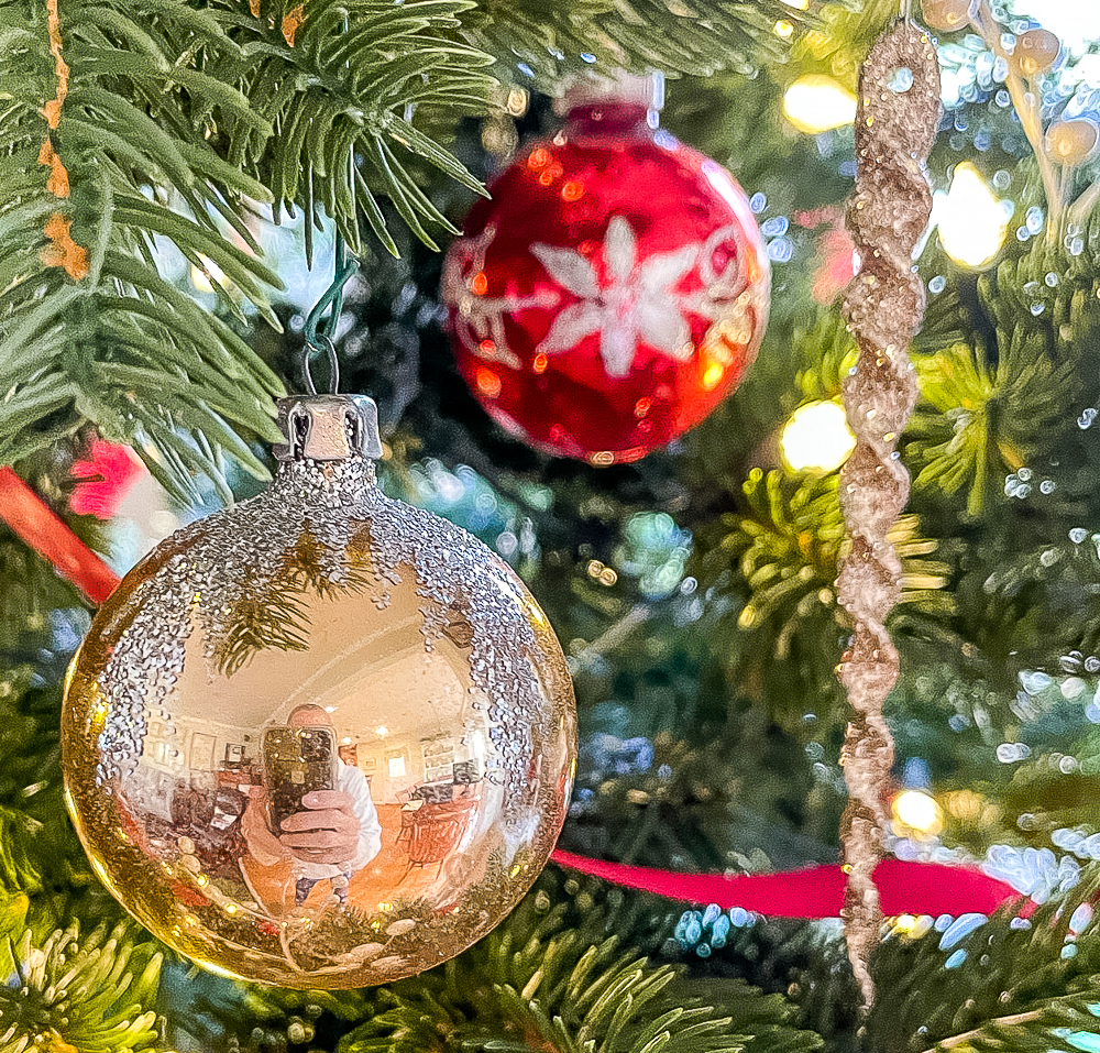 Red and gold vintage Christmas tree balls and a gilttery icicle