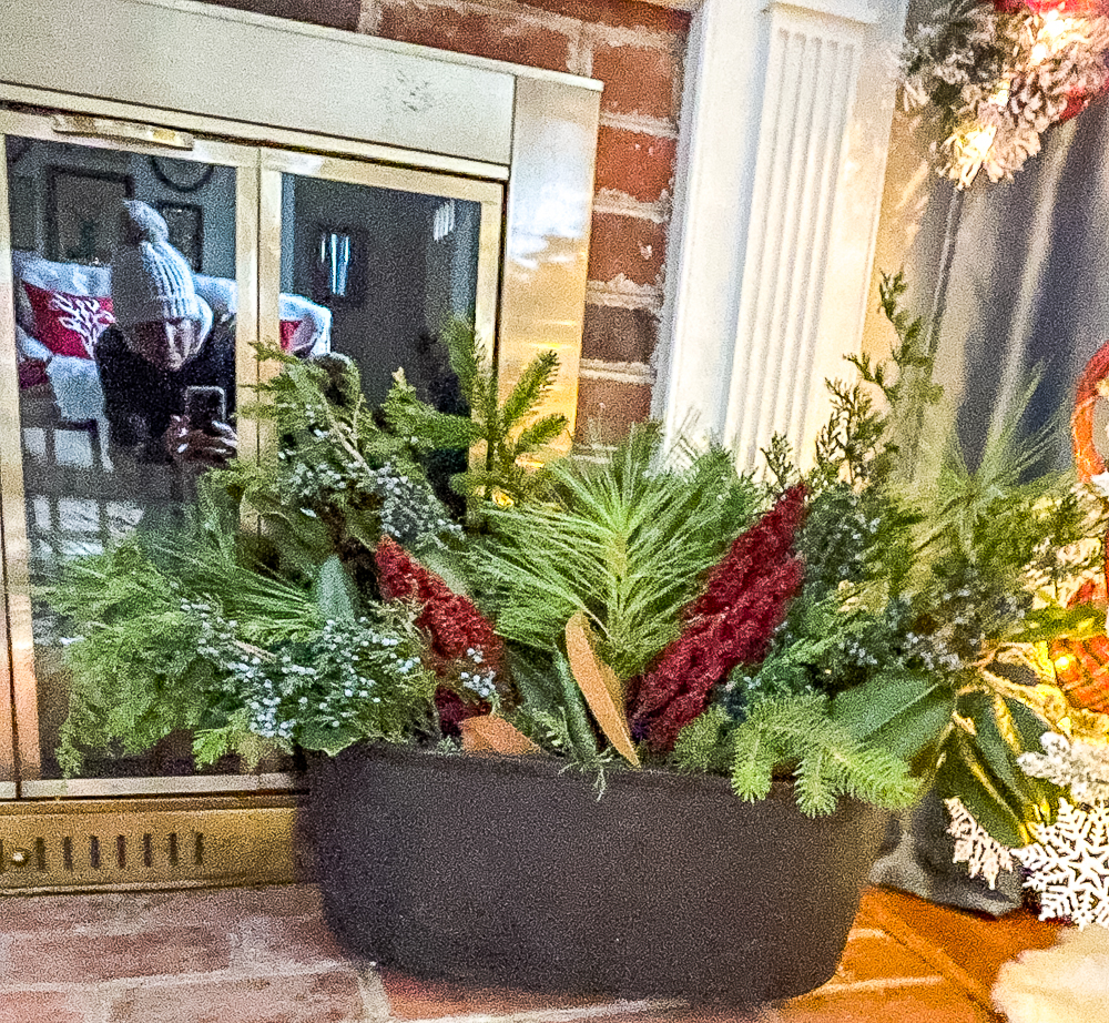 Cast iron tub on a fireplace hearth decorated for Christmas