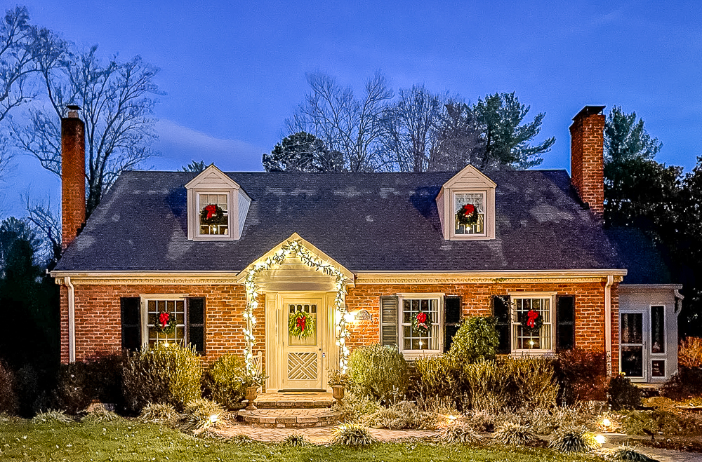 1958 Cape Cod decorated for Christmas with wreaths and lighted garland