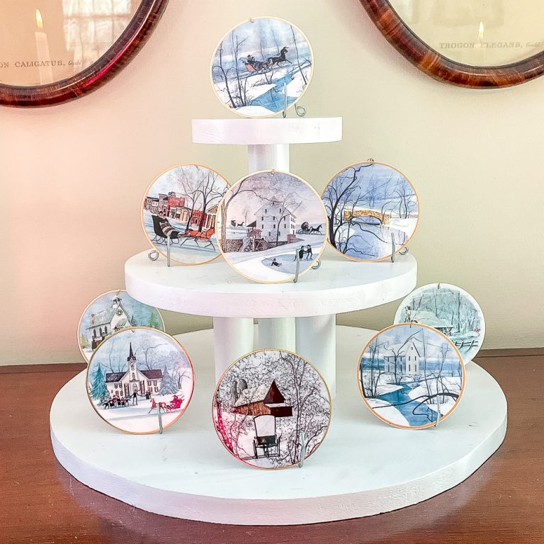 P. Buckley Moss ornaments on a cupcake stand